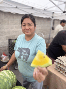 Woman offering Yellow Watermelon